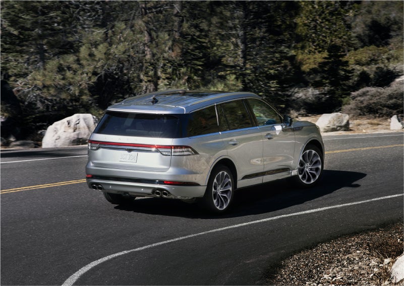 A 2023 Lincoln Aviator® Grand Touring model is shown being driven on a tight turn of a mountain road | Lincoln of Wayne in Wayne NJ