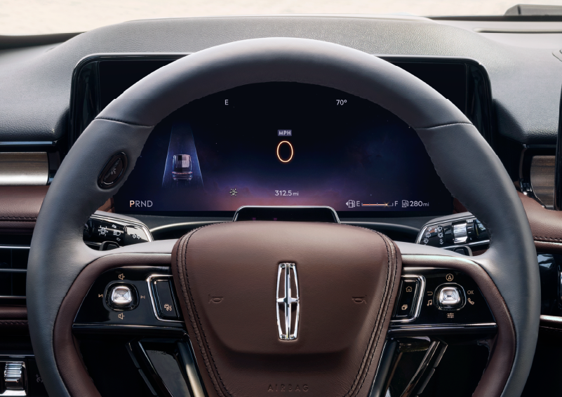 The steering wheel of 2025 Lincoln Aviator® SUV is shown with black and brown accents. | Lincoln of Wayne in Wayne NJ