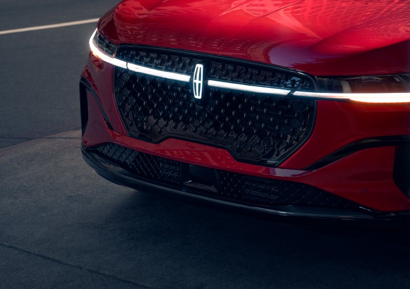 The available front LED light bar and center Lincoln Star logo glow at dusk. | Lincoln of Wayne in Wayne NJ