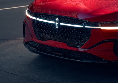 The available front LED light bar and center Lincoln Star logo glow at dusk. | Lincoln of Wayne in Wayne NJ