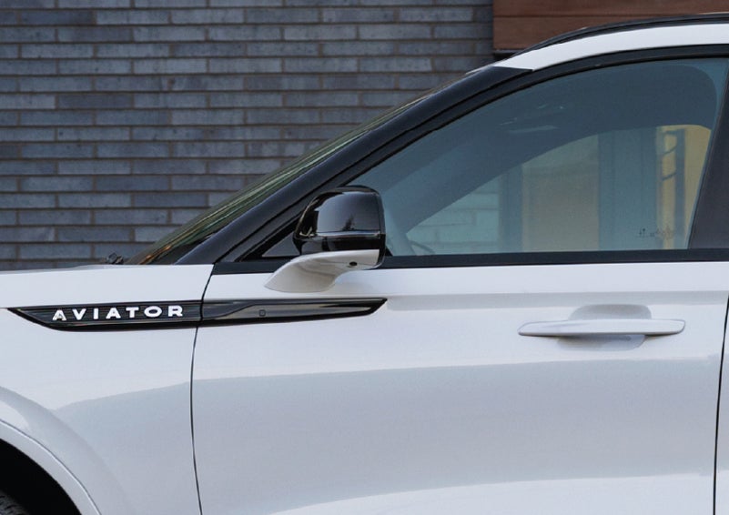 The driver’s side door and fender badging of a white 2026 Lincoln Aviator® SUV are showcased. | Lincoln of Wayne in Wayne NJ