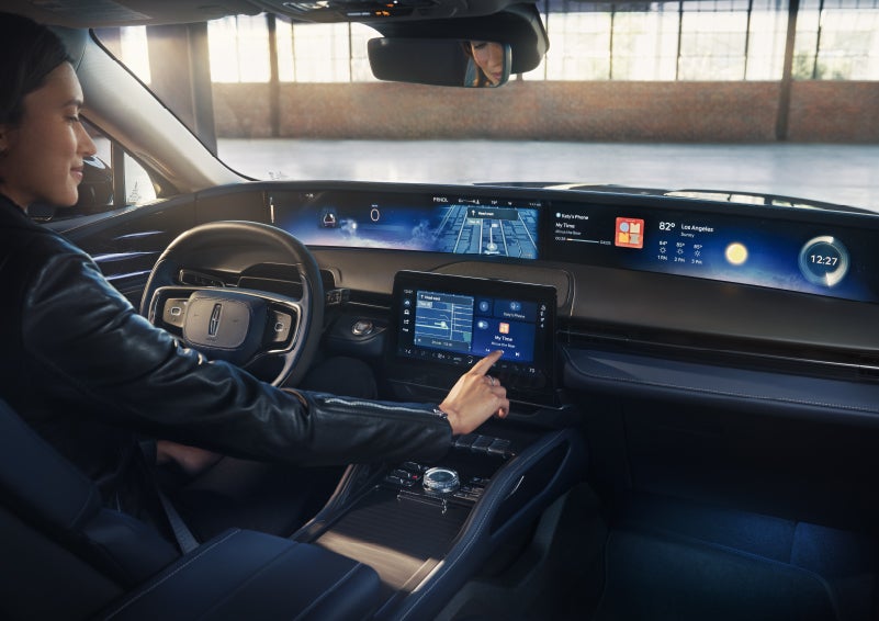 The driver of a 2026 Lincoln Nautilus® SUV interacts with the center touchscreen. | Lincoln of Wayne in Wayne NJ