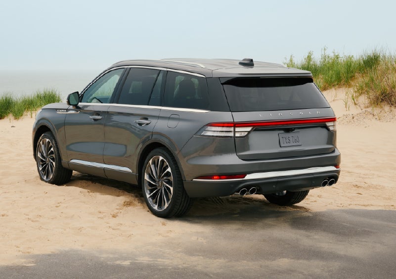 A 2027 Lincoln Aviator® SUV is parked next to sand dunes. | Lincoln of Wayne in Wayne NJ