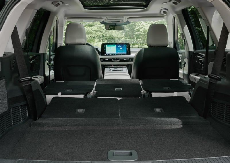 A rear to front view of the interior of a 2027 Lincoln Aviator® Black Label™ SUV shows the third and second rows folded flat | Lincoln of Wayne in Wayne NJ