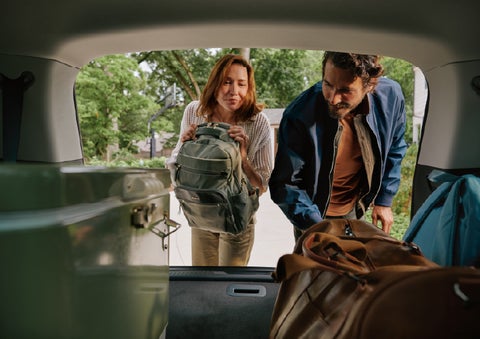 A couple loads luggage into the rear of a 2027 Lincoln Aviator® Black Label™ SUV..e 202 | Lincoln of Wayne in Wayne NJ