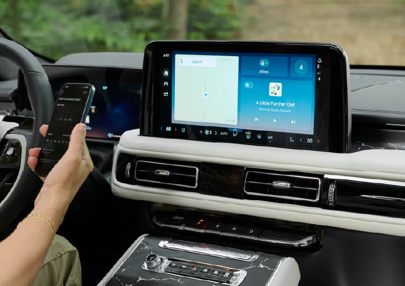 A person pairs thier phone with the center touchscreen of a 2027 Lincoln Aviator® Black Label™ SUV | Lincoln of Wayne in Wayne NJ