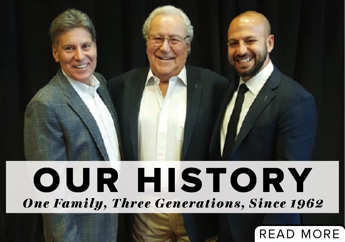 Three men, two wearing suits and one wearing a sport coat, smile at the camera. Text: OUR HISTORY, One Family, Three Generations, Since 1962.